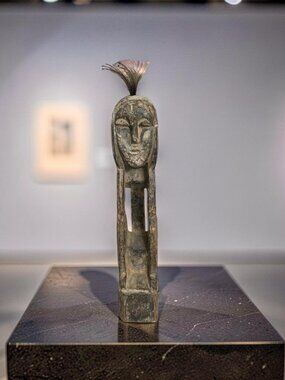 Vintage African hand-carved wooden tribesman figurine featuring a contemplative